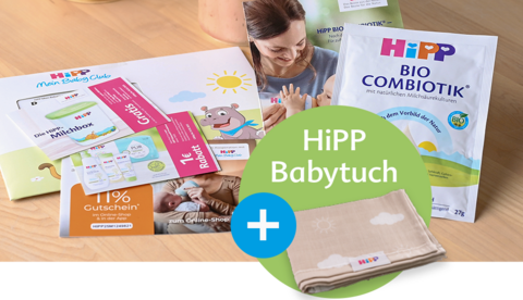 Eine Werbebox von 'BabyClub' mit einer grünen Faltflasche, einer 'Bio Combiotik'-Packung und einer Blattpflanze in einem Korb.