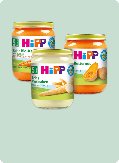 Drei Gläser mit Babynahrung, jedes mit einem anderen Obst- und Gemüsesorten und einem BIO"-Etikett.